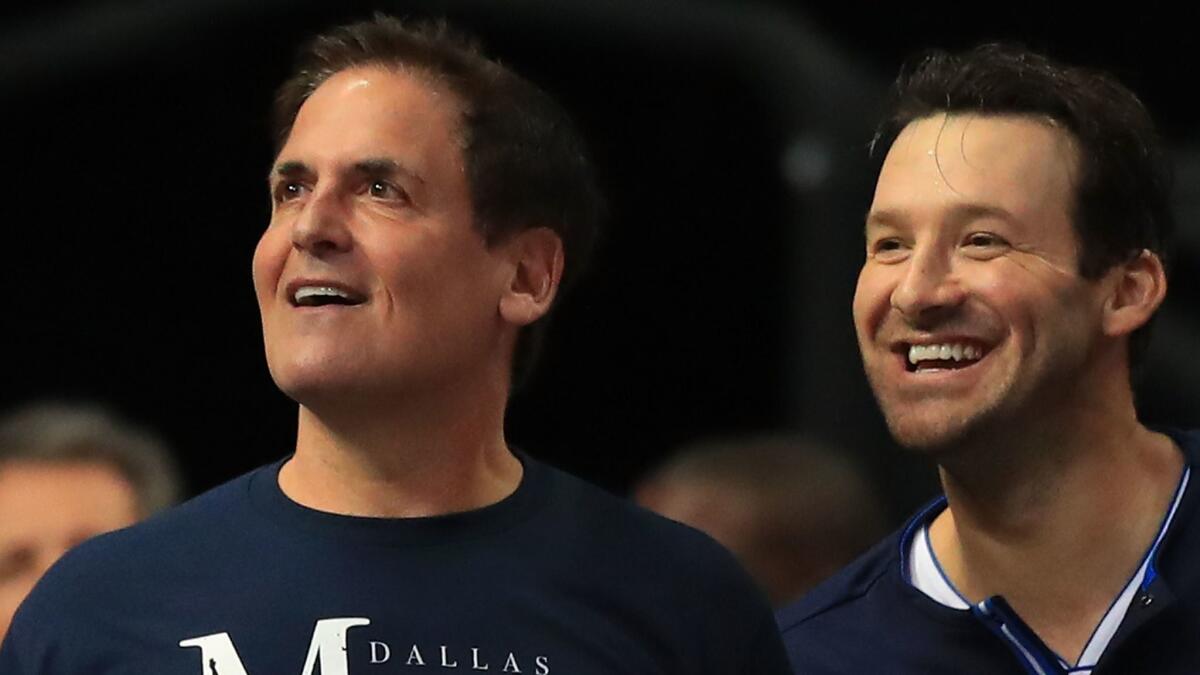 Former Dallas Cowboys quarterback Tony Romo, right, sits with Dallas Mavericks owner Mark Cuban at the Mavericks' final home game of the season April 11 against Denver.