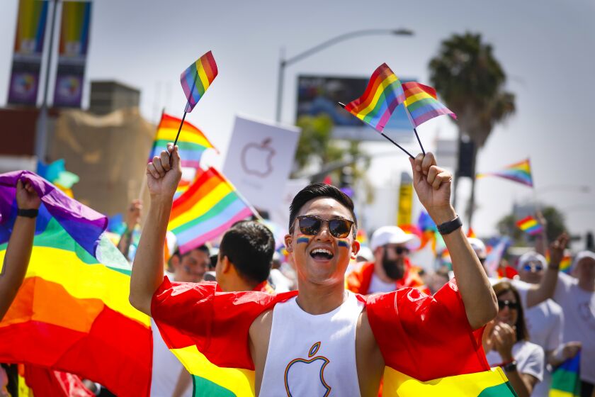 Ian Recio walks in the Apple contingent along the parade route during the annual San Diego Pride Parade.