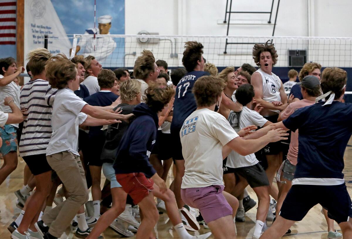 Newport Harbor players are stormed by supporters after upsetting Los Angeles Loyola, 3-1, in the semifinals on Saturday.