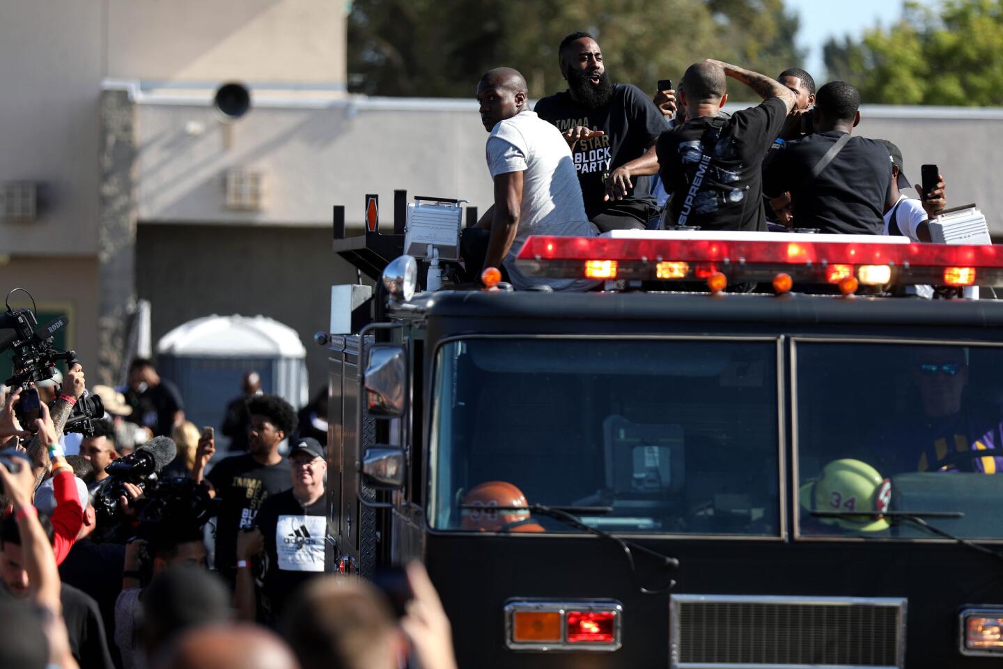 NBA star James Harden arrives on a firetruck at the "Imma be a star" block party on Sunday at Audobon Middle School, where he helped dedicate new basketball courts on the campus.