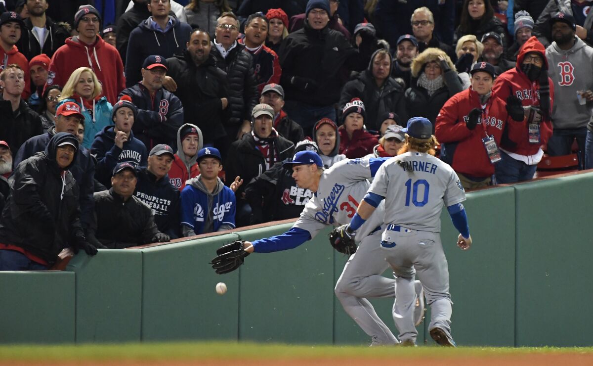Dodgers Joc Pederson and Justin Turner cannot catch a bloop double by Andrew Benintendi in the seventh inning.