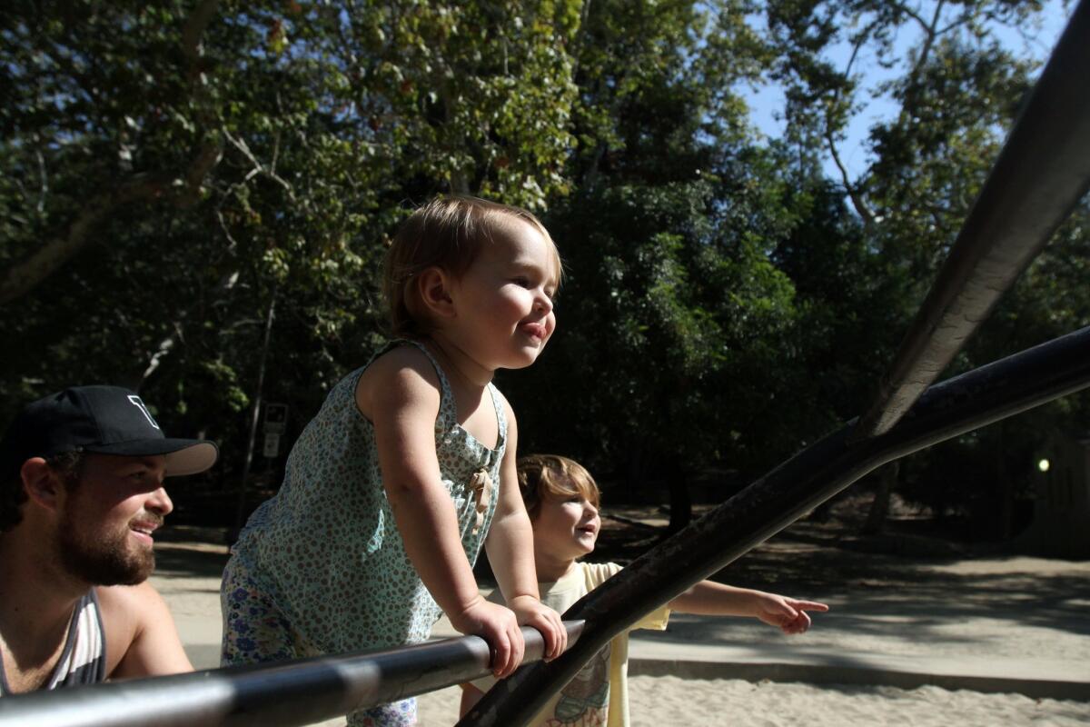 Alex Van Wagner, his daughter, Ever, 1, and son, Lennon, 2, enjoy the playground at Griffith Park.