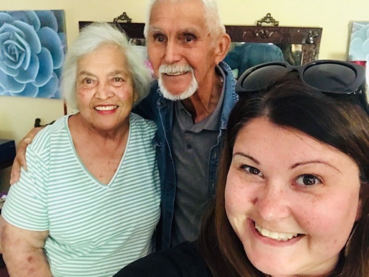 Kristine Shipman poses with her grandparents Elizabeth Rajcan-Nevarez and Ezekiel Nevarez in June.