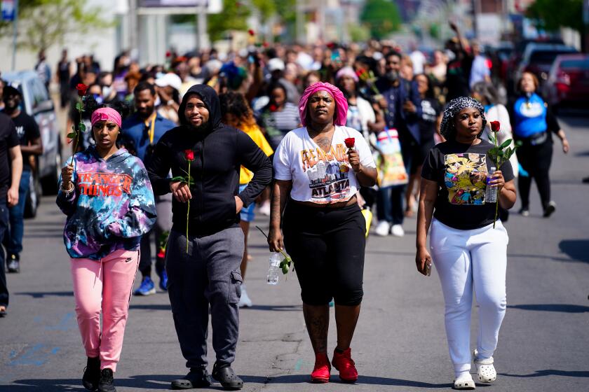 People march to the scene of a shooting at a supermarket in Buffalo, N.Y., Sunday, May 15, 2022. (AP Photo/Matt Rourke)