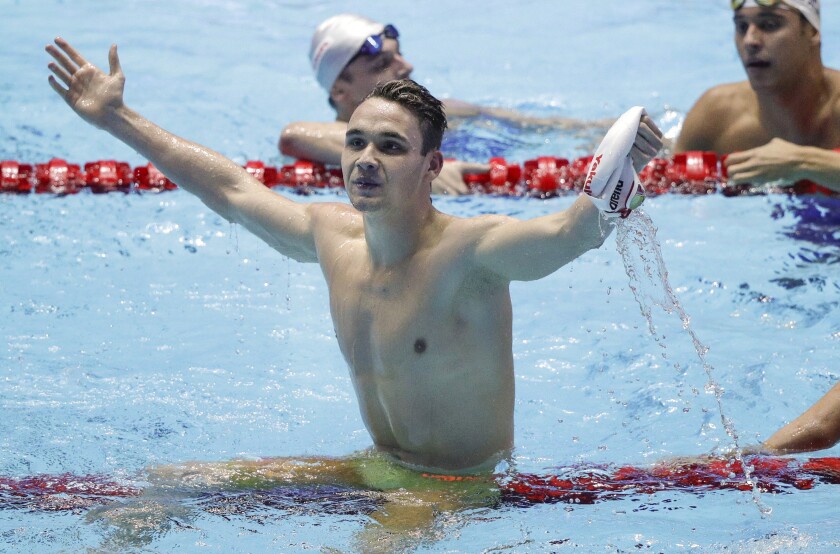 Hungary's Kristof Milak celebrates after setting a world record in the men's 200-meter butterfly at the world swimming championships Wednesday in Gwangju, South Korea.