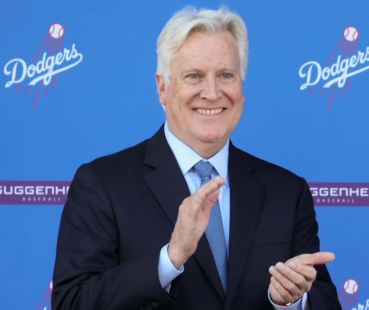 Dodgers majority owner Mark Walter stands claps during the introduction of star Shohei Ohtani