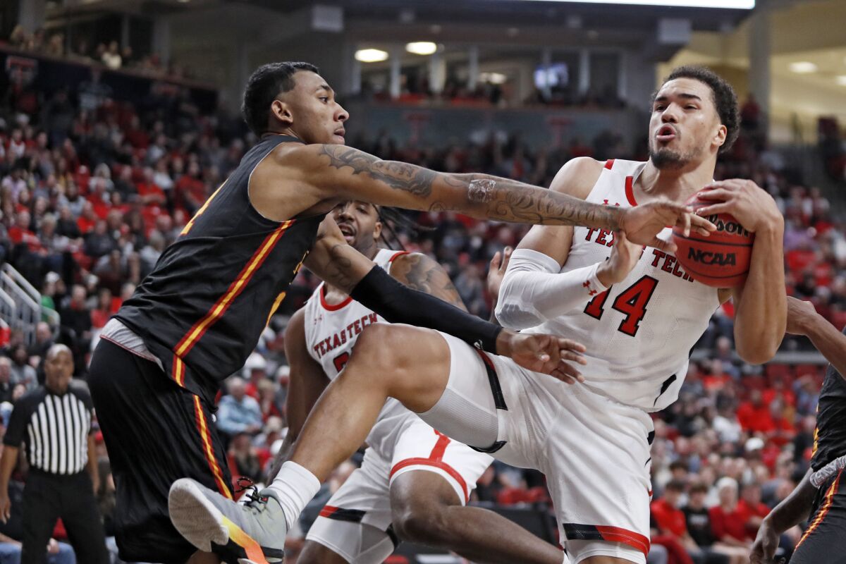 Texas Tech's Marcus Santos-Silva (14) rebounds the ball away from Grambling State's AJ Taylor (14) during the first half of an NCAA college basketball game against Grambling State, Friday, Nov. 12, 2021, in Lubbock, Texas. (Brad Tollefson/Lubbock Avalanche-Journal via AP)