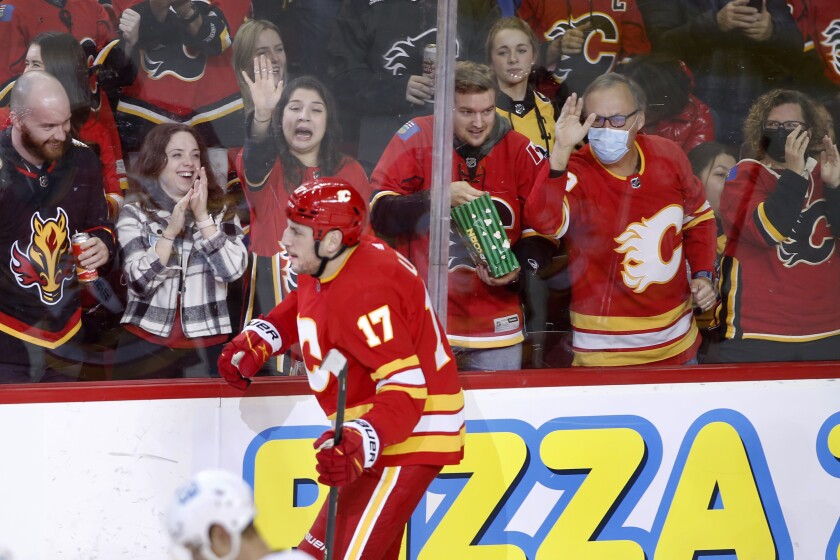 Calgary Flames' Milan Lucic and fans celebrate his goal against the Pittsburgh Penguins during the second period of an NHL hockey game, Monday, Nov. 29, 2021 in Calgary, Alberta. (Larry MacDougal/The Canadian Press via AP)