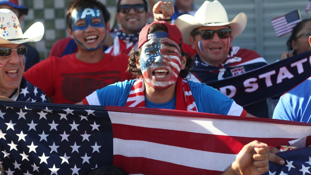 U.S. fans celebrate during the team's 2-2 World Cup draw against Portugal on Sunday. U.S. fans attending the World Cup in Brazil outnumber fans from every other country except the host nation.