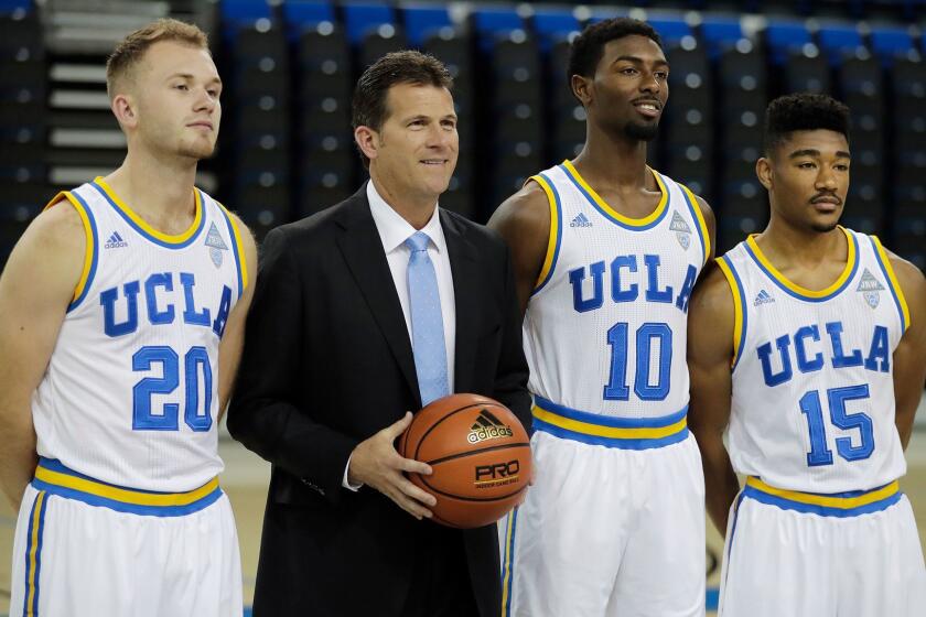 UCLA players Bryce Alford, left, Isaac Hamilton and Jerrold Smith pose with Coach Steve Alford on Oct. 12.