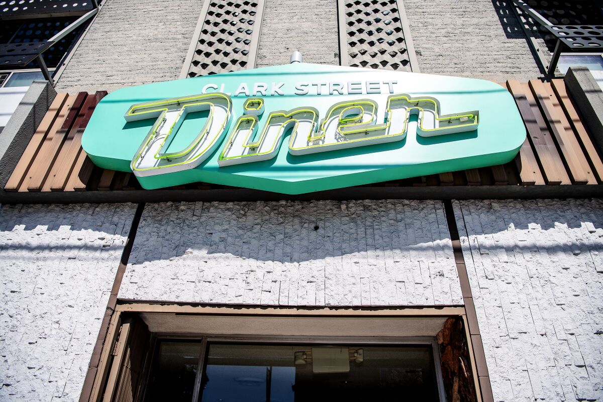 The turquoise sign above a door reads Clark Street Diner.
