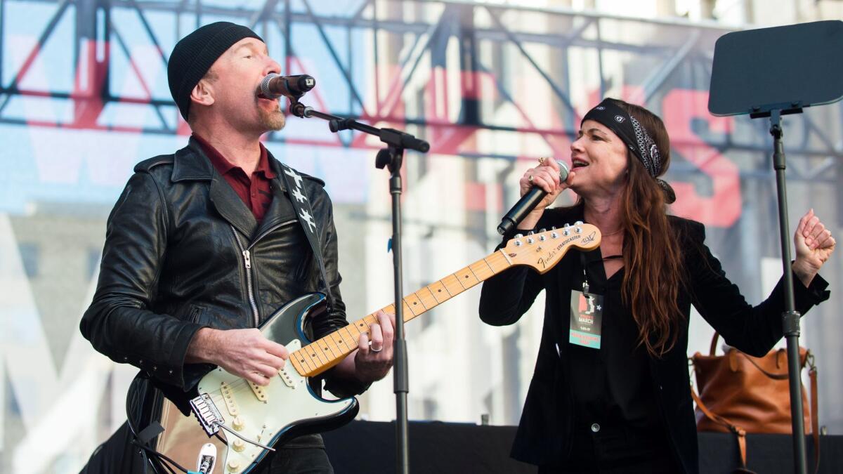 The Edge and Juliette Lewis perform Saturday during the Women's March in Los Angeles.