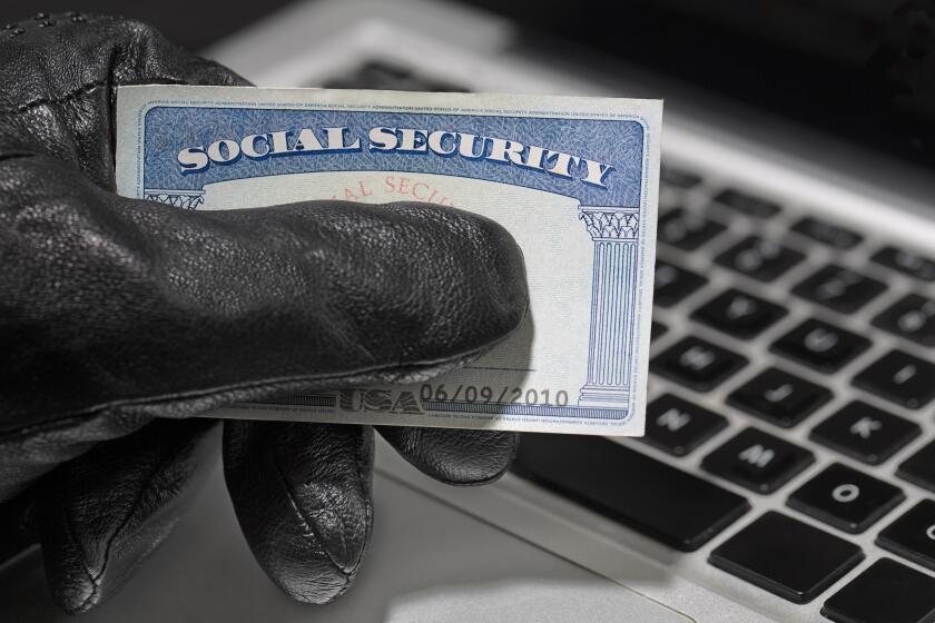 Thief holding a social security card.