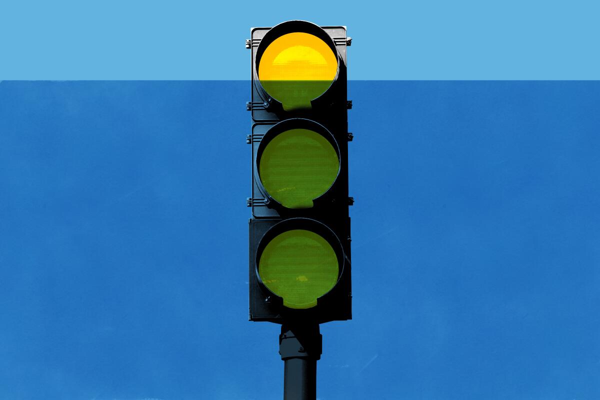 Illustration of a traffic light with three yellow lights almost completely submerged in water.
