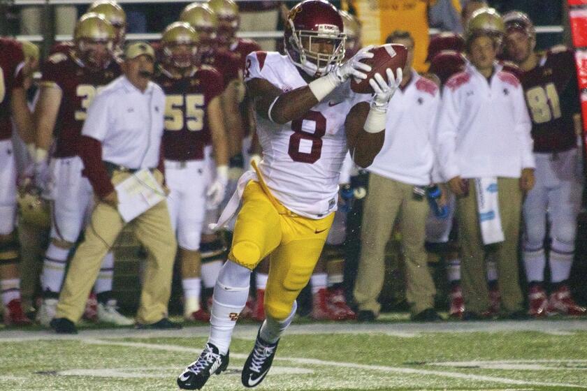 USC's George Farmer takes the pitch on a wide receiver reverse play against Boston College.