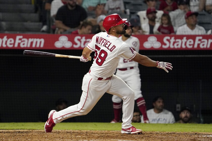 Angels' Jack Mayfield hits a two-run home run during the seventh inning against the Colorado Rockies.