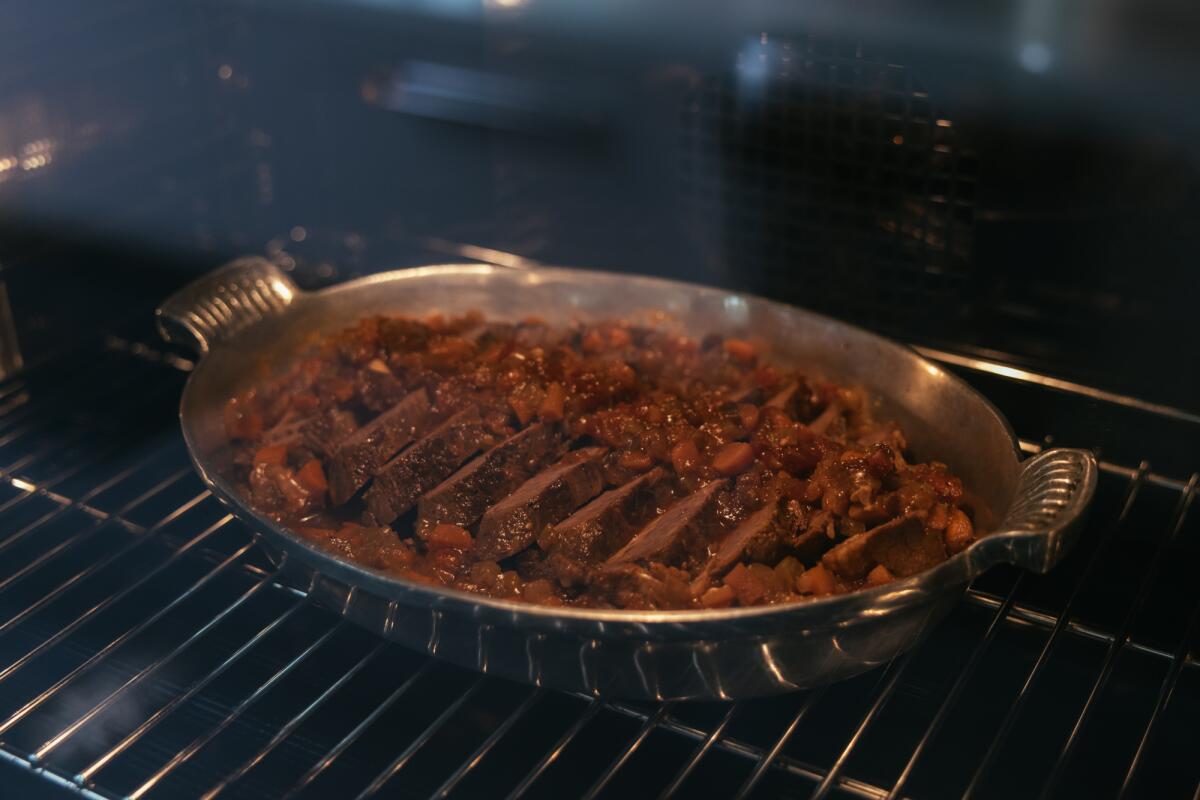 Sliced brisket is cooked in the oven at the Los Angeles Times' studio kitchen.