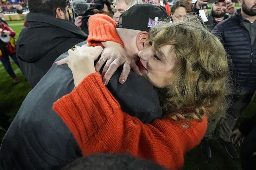 Taylor Swift speaks withKansas City Chiefs tight end Travis Kelce after an AFC Championship NFL football game against the Baltimore Ravens, Sunday, Jan. 28, 2024, in Baltimore. The Kansas City Chiefs won 17-10. (AP Photo/Julio Cortez)