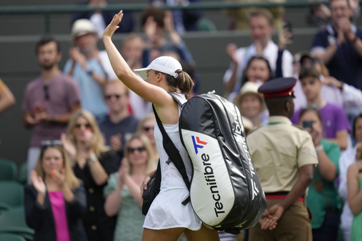 Poland's Iga Swiatek leaves the court after losing to France's Alize Cornet in a third round women's singles match on day six of the Wimbledon tennis championships in London, Saturday, July 2, 2022. (AP Photo/Kirsty Wigglesworth)