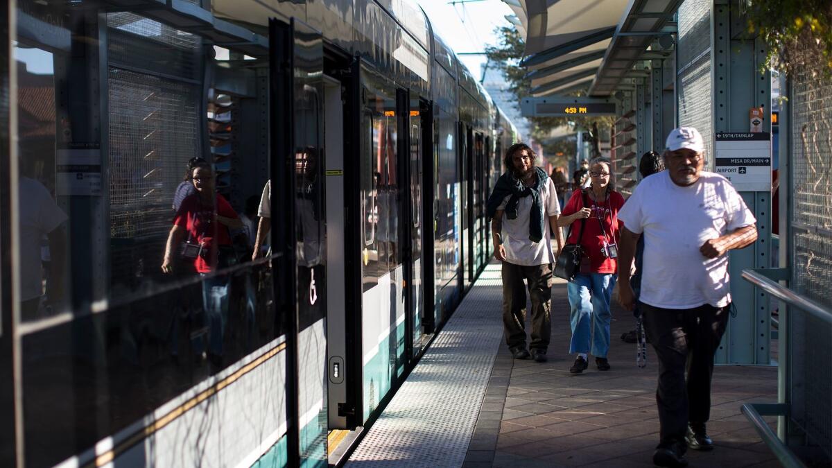 Shade structures keep pedestrians cool at a Metro light rail stop at McDowell and Central stop in downtown Phoenix.