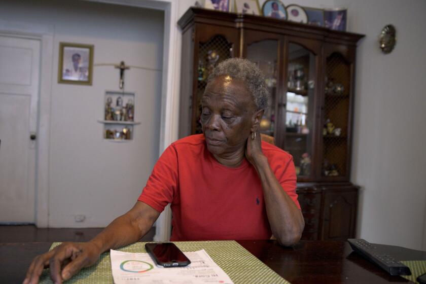 Mary C. Williams sits in her home in New Orleans on Friday, Feb. 4, 2022. Williams, who lives on a low fixed income, has high utility bills from Entergy, a major utility provider in Louisiana and three other Southern states, causing her to stress about keeping her lights on. (AP Photo/Matthew Hinton)