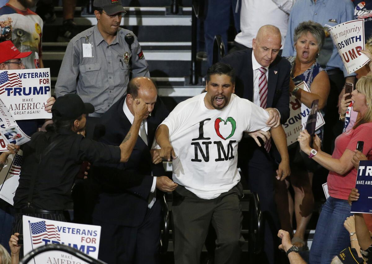 A protester is taunted as he is removed from a Donald Trump rally in Albuquerque on May 24, 2016.