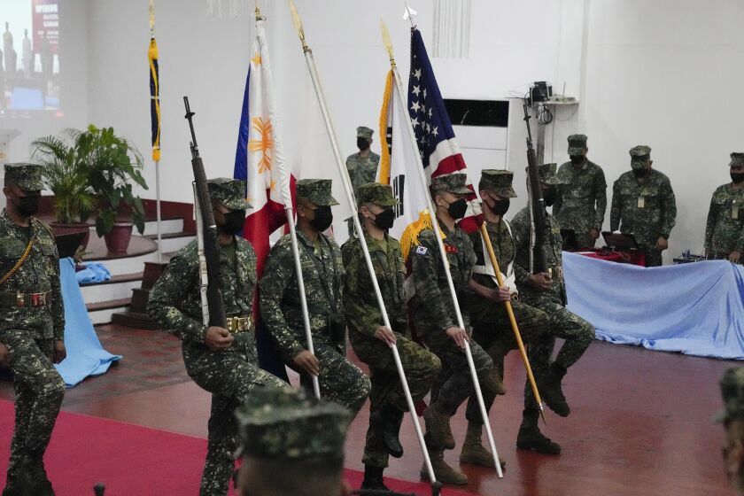 Marines from Philippines, Japan, South Korea and the United States carry their flag during opening ceremonies of an annual joint military exercise called Kamandag the Tagalog acronym for "Cooperation of the Warriors of the Sea" at Fort Bonifacio, Taguig city, Philippines on Monday Oct. 3, 2022. More than 2,500 U.S. and Philippine marines launched combat exercises Monday to be able to jointly respond to any sudden crisis in a region long on tenterhooks over the South China Sea territorial disputes and ChinaÅfs increasingly hostile actions against Taiwan. (AP Photo/Aaron Favila)