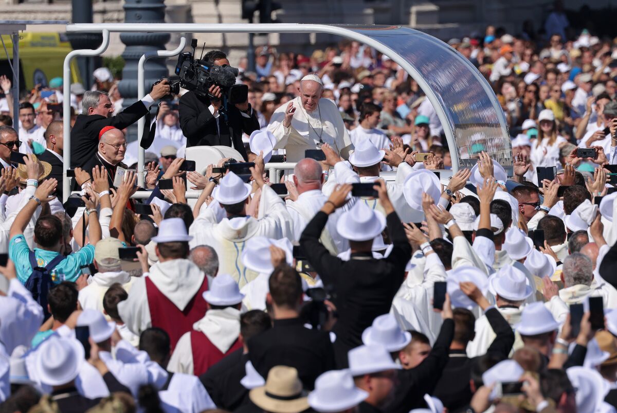 Pope Francis greets Catholic pilgrims as he arrives in the Popemobile