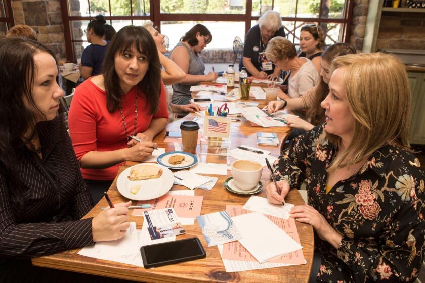 CHESTERFIELD, VIRGINIA - OCTOBER 2: Becky Conner, Sidra Butt and Kim Drew Wright (left-right) meet with about 20 women who are part of "Liberal Women of Chesterfield County" at a local coffee shop on a Tuesday morning to write post cards to their politicians Chesterfield County, VA on October 2, 2018. (Photo by Jay Paul for Los Angeles Times) 3060705 la-ca-lib-women-chesterfield-county