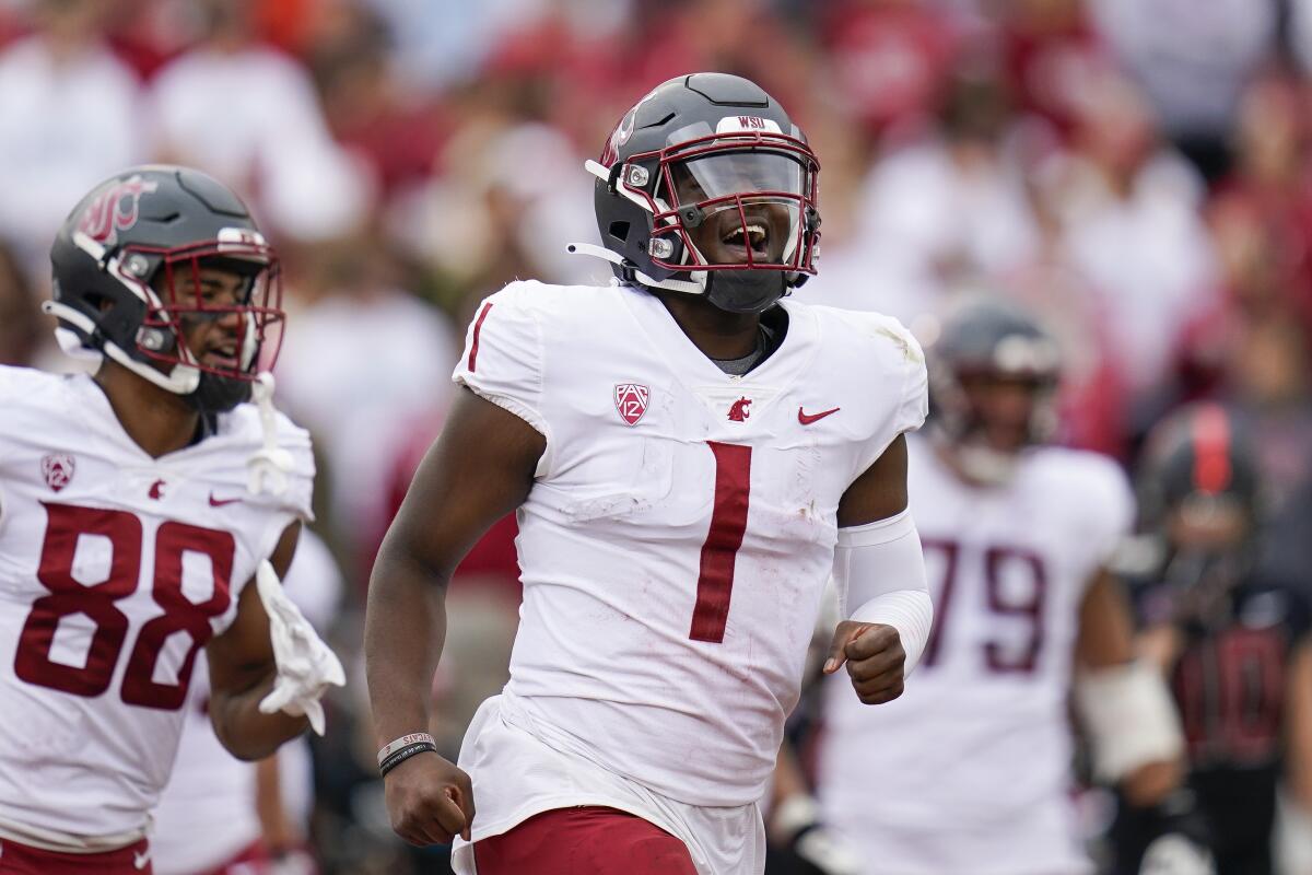Washington State quarterback Cameron Ward (1) celebrates after throwing a touchdown against Stanford during the first half of an NCAA college football game in Stanford, Calif., Saturday, Nov. 5, 2022. (AP Photo/Godofredo A. Vásquez)