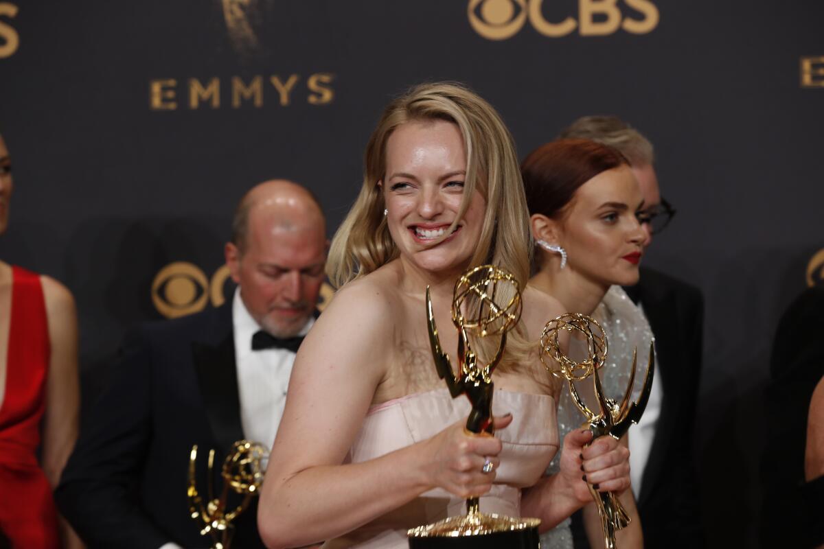 Elisabeth Moss clutches two Emmys at the 2017 ceremony.