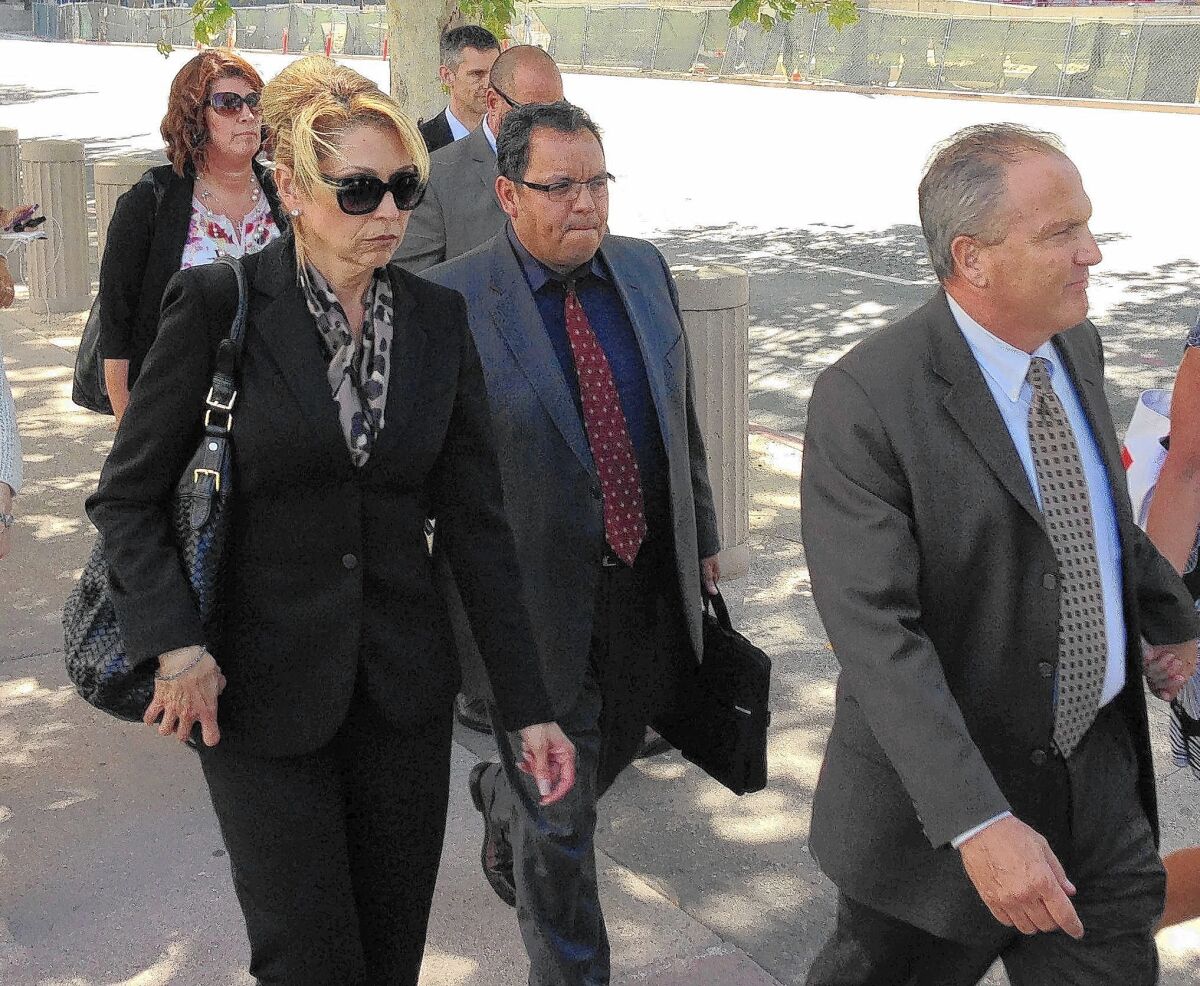 Sgt. Maricela Long, left, and Lt. Stephen Leavins, far right, leave the federal courthouse after sentencing Tuesday. Long got 24 months and Leavins 41 months.