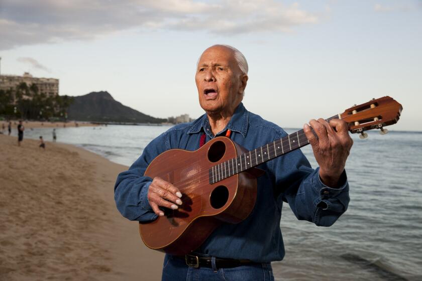 Ukulele legend Eddie Kamae plays a few songs on Waikiki Beach.