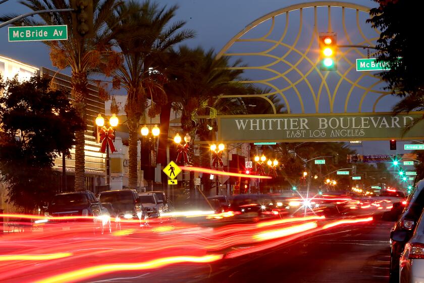 LOS ANGELES, CALIF. - DEC. 17, 2020. Motor traffic streams down Whittier Boulevard in East Los Angeles, an area that has been hard hit by the coronavirus. Nearly 12,000 people in the neighborhood have tested positive for the virus. (Luis Sinco/Los Angeles Times)