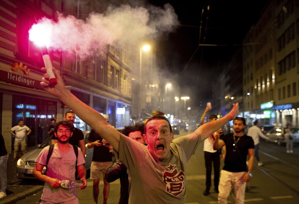 Eintracht Frankfurt fans celebrate their team's victory against the Rangers in the Europa League final soccer match, in Frankfurt/Main, Germany, Wednesday, May 18, 2022. Frankfurt defeated the Rangers 5-4 in a penalty shootout after the match had ended in a 1-1 draw. (Boris Roessler/dpa via AP)