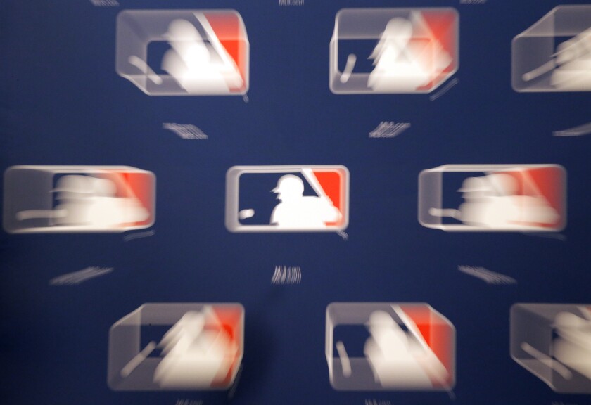 A slow shutter speed and lens zoom creates a blur of the MLB logos. Owners have proposed a 76-game season for 2020.