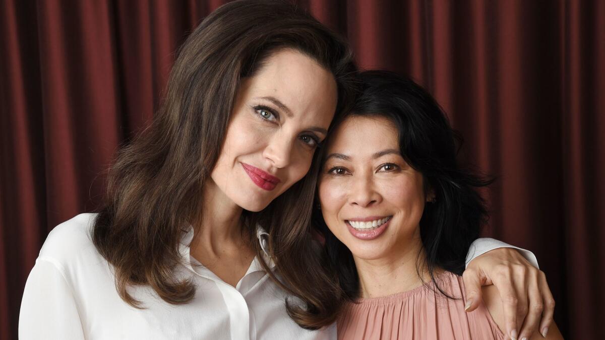 Director Angelina Jolie, left, brings Loung Ung's memoir to the screen in "First They Killed My Father," a harrowing drama now available on Netflix.