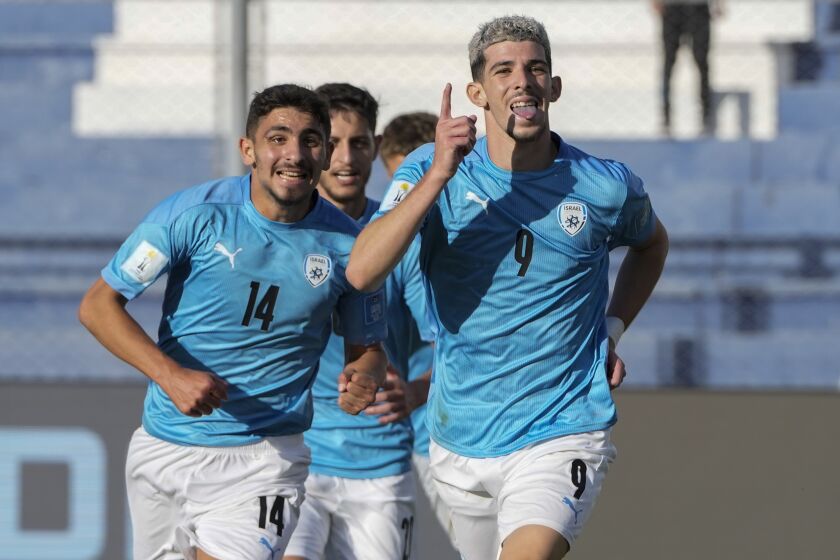Israel's Dor Turgeman, right, celebrates with teammates after scoring his side's third goal during the extra time of a FIFA U-20 World Cup quarterfinal soccer match against Brazil at the Bicentenario stadium in San Juan, Argentina, Saturday, June 3, 2023. (AP Photo/Ricardo Mazalan)