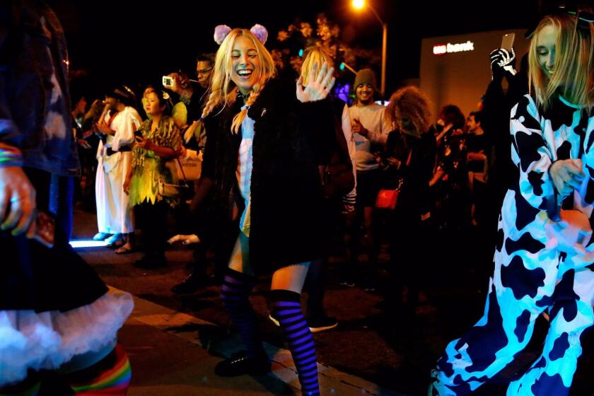 WEST HOLLYWOOD, CALIF. -- MONDAY, OCTOBER 31, 2016: Dancing to the music at the City of West Hollywood's 2016 Halloween Carnaval, in West Hollywood, Calif., on Oct. 31, 2016. The carnaval is the world's largest Halloween festivity with an estimated attendance of several hundred thousand people. This year's theme celebrates the disco era. (Gary Coronado / Los Angeles Times)
