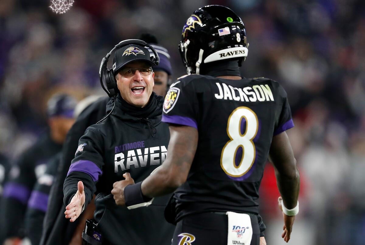 Ravens coach John Harbaugh congratulates quarterback Lamar Jackson.