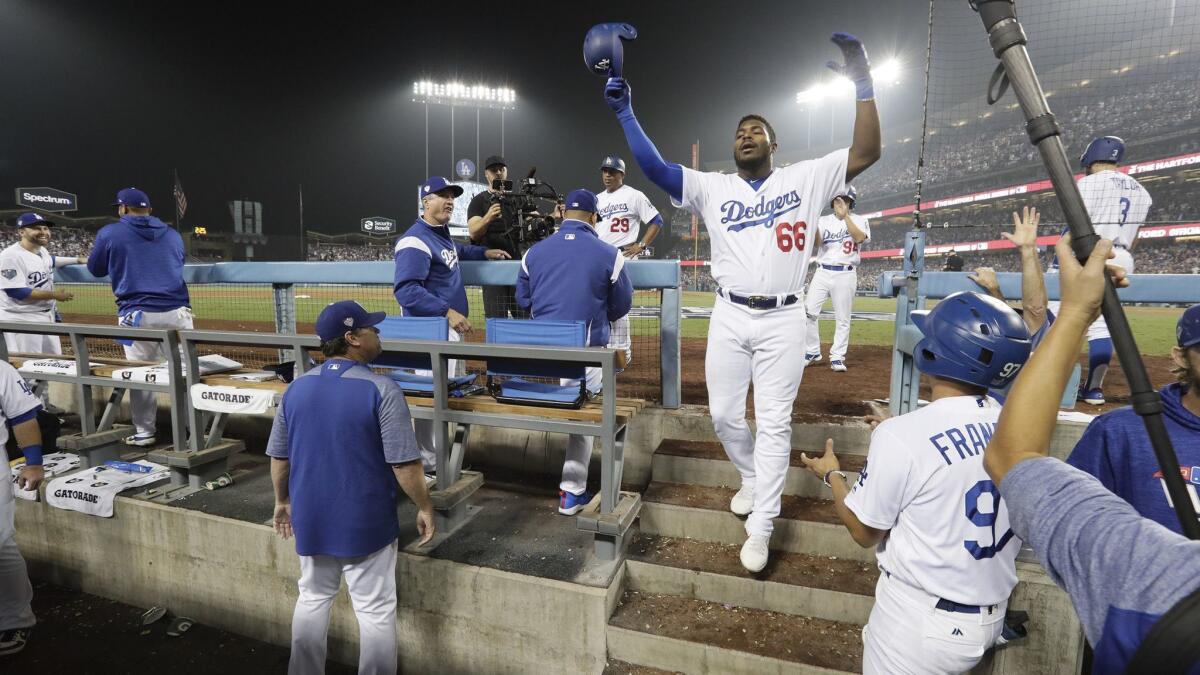 Yasiel Puig takes a curtain call after hitting a three-run homer in the sixth inning in Game 4 of the 2018 World Series at Dodger Stadium.