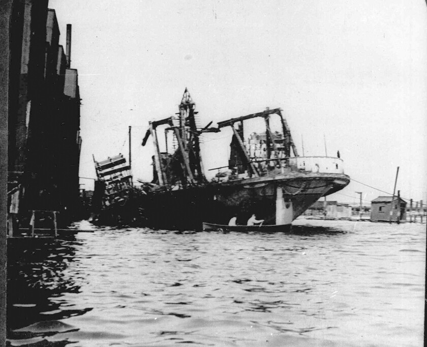 FILE - The excursion boat General Slocum lies beached off Hell Gate in New York City's East River, following a fire and resulting panic, June 15, 1904. The disaster cost the lives of 1,030 mostly German immigrants. (AP Photo, File)