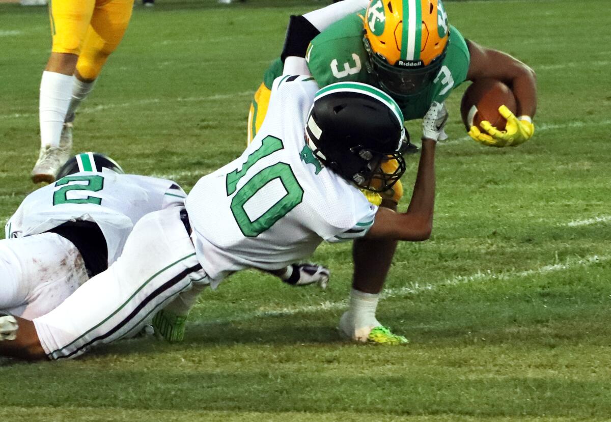 Costa Mesa's Brody Leonard (10) tackles Kennedy's Rider Street (3) in the season opener at Western High on Thursday.