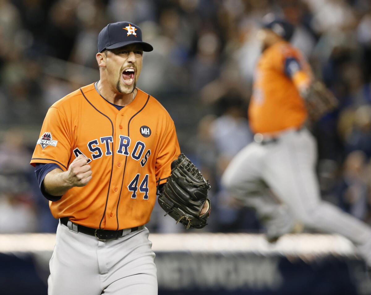Astros closer Luke Gregerson (44) reacts as a fellow teammate leaps in the air after the final out of the Astros' 3-0 shutout of the Yankees in the American League wild card game.