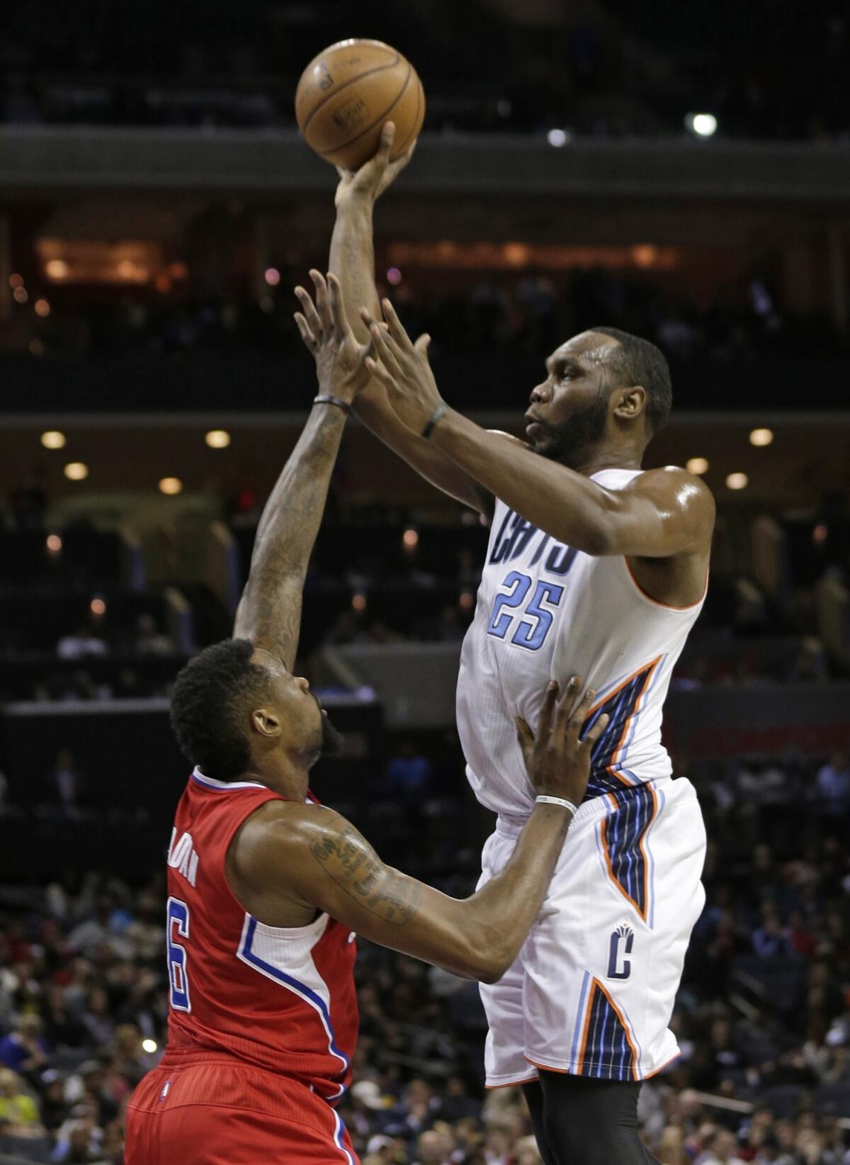 Bobcats center Al Jefferson, right, shoots over Clippers center DeAndre Jordan during a game in Charlotte, N.C.