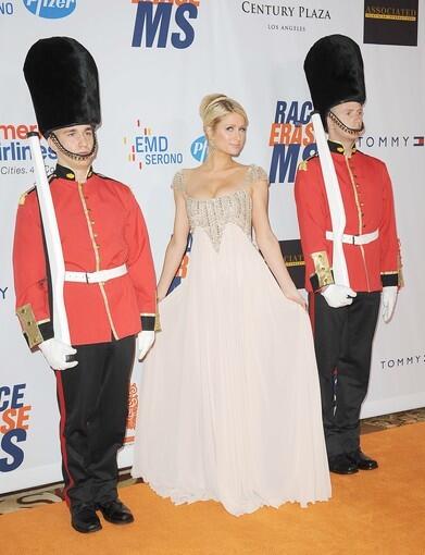 While the British were busy celebrating the royal wedding across the pond, Hollywood was having a little British fun of its own at the 18th Annual Race to Erase MS gala. This year's party and fundraiser at the Hyatt Regency Century Plaza featured royal guards on the red carpet and William and Kate look-alikes. Paris Hilton, a longtime supporter of the cause, does her best princess pose, while the guards maintain a stiff stare.