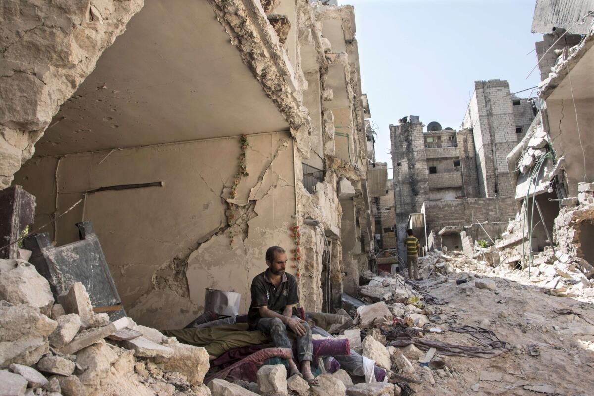 A Syrian man sits amid the rubble in the northern Syrian city of Aleppo on Sept. 17, 2015.