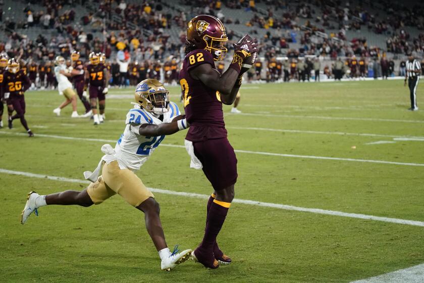Arizona State wide receiver Andre Johnson (82) beats UCLA defensive back Jaylin Davies (24) for a two-point conversion during the second half of an NCAA college football game in Tempe, Ariz., Saturday, Nov. 5, 2022. UCLA won 50-36. (AP Photo/Ross D. Franklin)