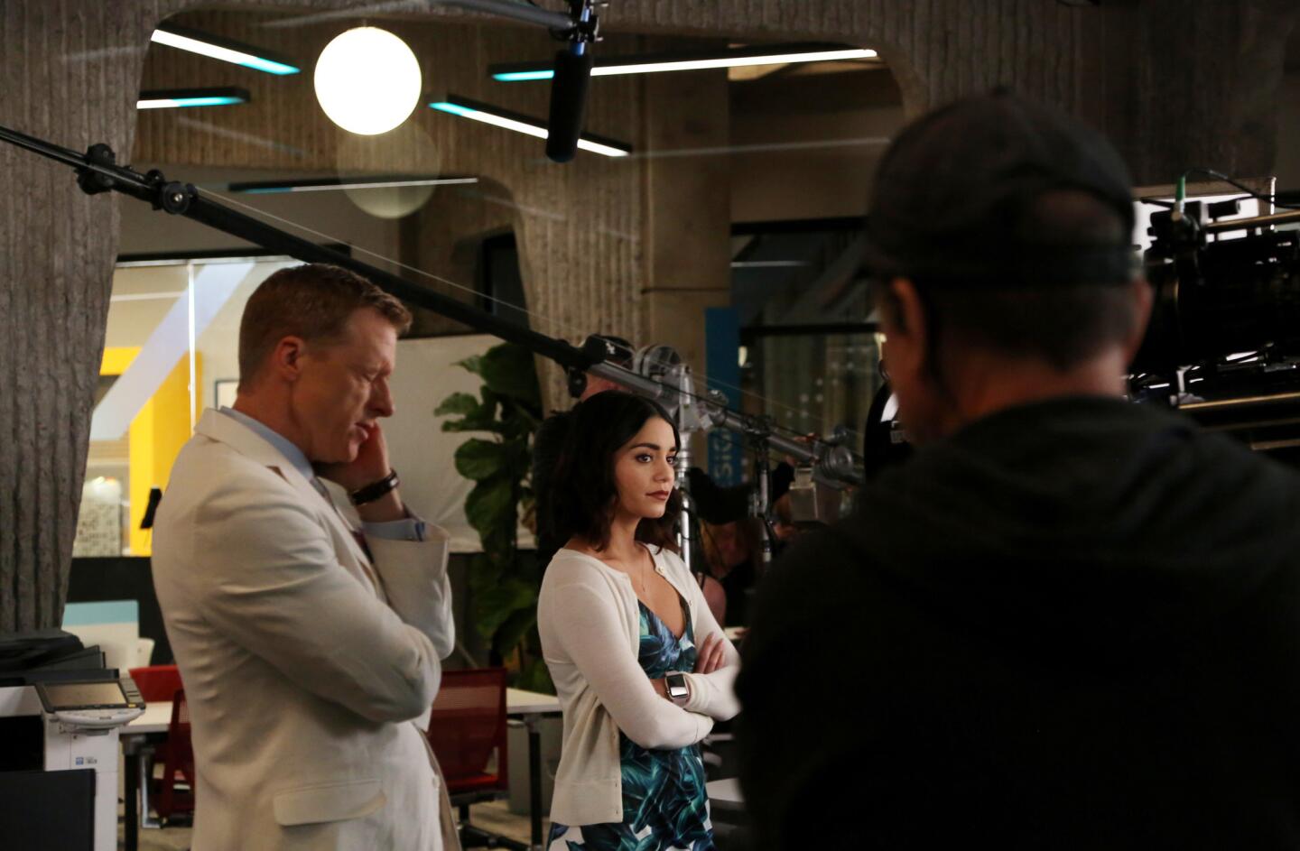 Alan Tudyk, left, and Vanessa Hudgens shoot a scene of the NBC comedy "Powerless," filmed on the Warner Brothers Studio lot. "Powerless" takes place in the DC Universe and follows the adventures of Emily Locke (Hudgens) as director of research and development at Wayne Security, which specializes in products for ordinary humans who are poised to be victims of the battles between superheroes and supervillians.