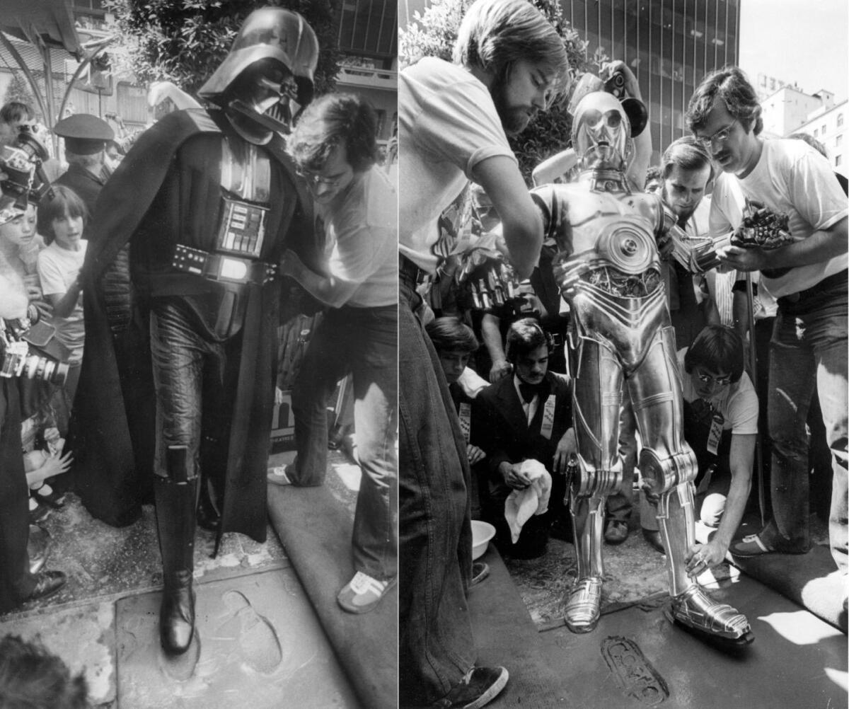 C-3PO and Darth Vader add a little science fiction to the Forecourt of the Stars at the Chinese Theatre on Aug. 3, 1977.